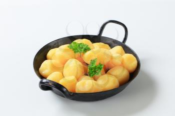 Cooked potatoes on a black pan