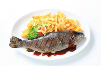 Grilled trout and French fries with barbecue sauce