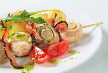 Skewer of button mushrooms with crispy bacon and potatoes