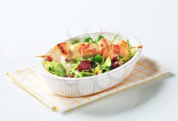 Chicken skewer and mixed salad greens