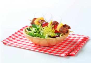 Grilled pork skewer and spring salad mix