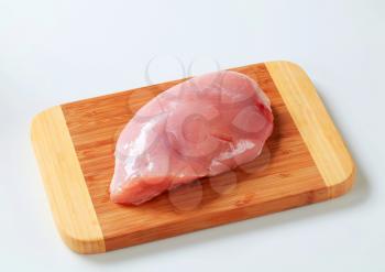 Fresh turkey breast fillet on cutting board