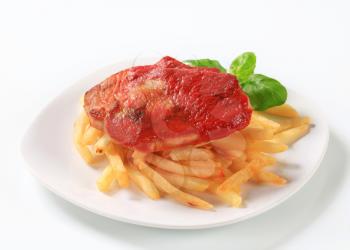 Pan seared pork chop with tomato sauce and French fries
