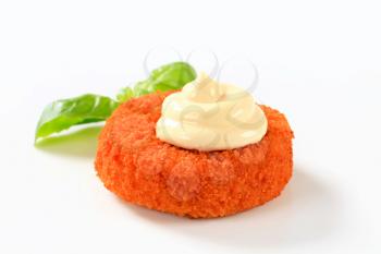 Fried breaded cheese or fish cake with mayonnaise