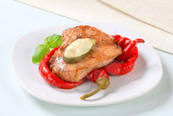 Spicy glazed pork chop with pickled peppers