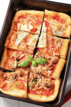 Rectangular pizza topped with blue cheese and tuna
