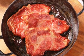 Pan roasted slices of smoked pork neck