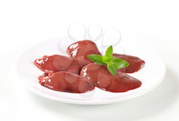 Raw chicken liver on white plate