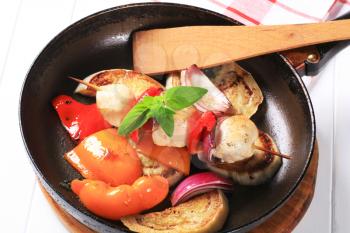 Pan roasted vegetables and chicken skewer in a frying pan