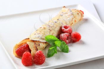 Crepe with fresh raspberries powdered with icing sugar