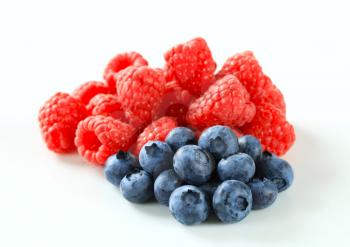 Studio shot of fresh raspberries and blueberries