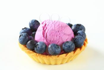 Scoop of fruit ice cream with fresh blueberries in a tart shell