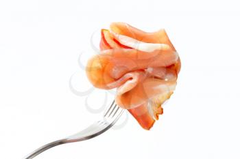 Thin slices of Prosciutto on a fork