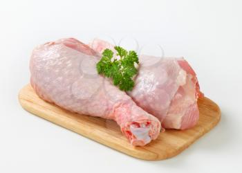 Raw turkey legs on cutting board