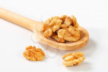 Fresh walnuts on wooden scoop