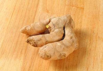 Fresh ginger root on wooden background