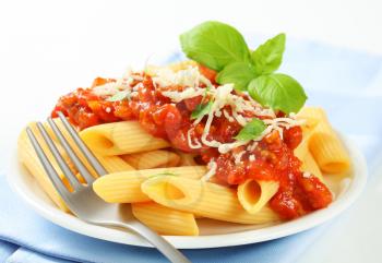 Penne pasta with meat-based tomato sauce and cheese