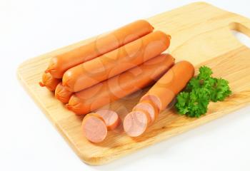 Stack of sausages on cutting board