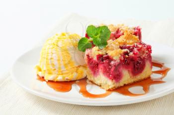 Berry fruit crumble cake with ice cream and syrup