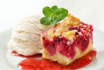 Berry fruit crumble slice with ice cream and raspberry sauce
