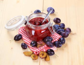 Jar of plum preserve and fresh plums - still