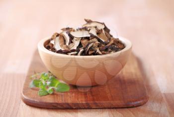 Dried mushrooms in a wooden bowl 