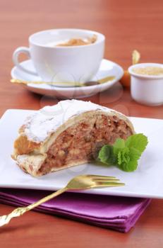 Slice of apple strudel and a cup of coffee