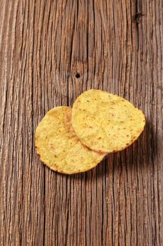 Two tortilla chips on wood - closeup