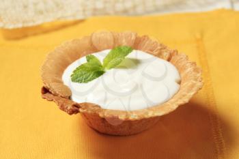Wafer cup filled with lemon cream