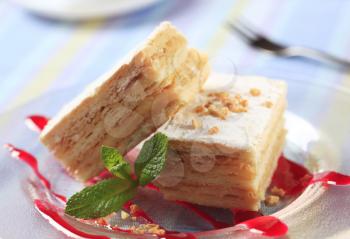 Slices of apple mille-feuille cake dusted with powdered sugar