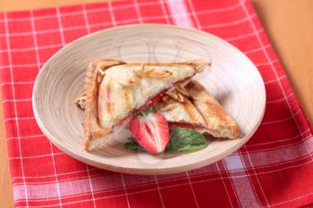 Toasted sandwich filled with strawberry jam