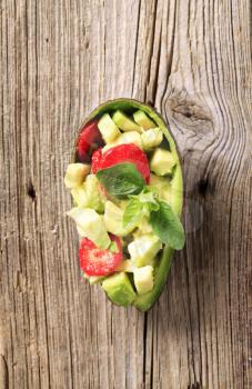 Avocado and slices of strawberry - overhead