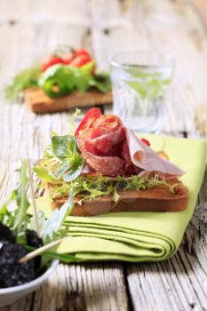 Toast with ham and vegetable topping - closeup
