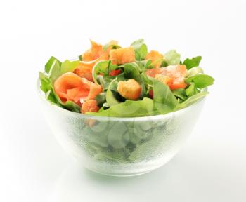 Bowl of greens with smoked salmon and croutons