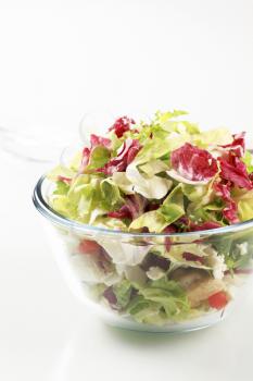Salad greens in a glass bowl - studio