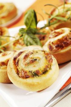 Puff pastry swirls with herb and cheese filling
