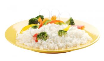 Boiled rice with vegetables on a yellow plate