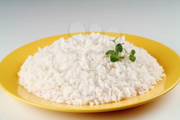 Boiled white rice on a yellow plate