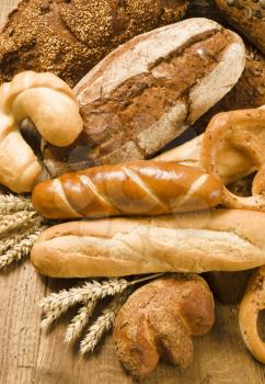 Various kinds of bread on wooden table