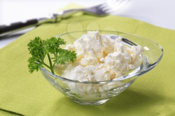 Bowl of curd cheese garnished with parsley