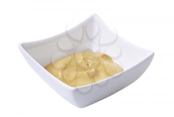 Creamy mustard in a small square bowl 