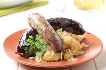 Blood sausage and white pudding with sauerkraut and potatoes