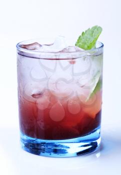 Glass of cocktail drink with ice - studio