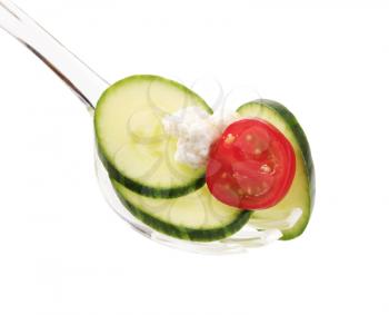 Slices of cucumber and cheese on a salad spoon
