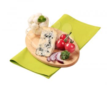 Blue cheese and mozzarella on cutting board
