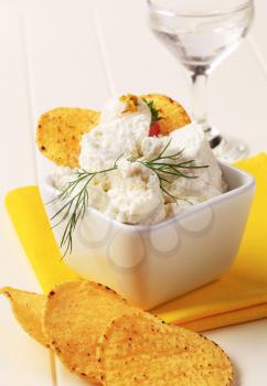 Corn chips and bowl of curd cheese