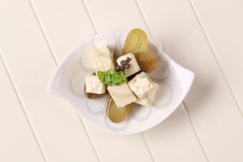 Cubes of marinated feta cheese and pickles