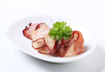Slices of roast bacon garnished with parsley