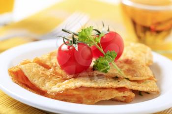 Egg omelets and two fresh tomatoes - closeup