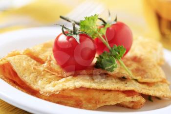 Egg omelets and fresh red tomatoes - detail